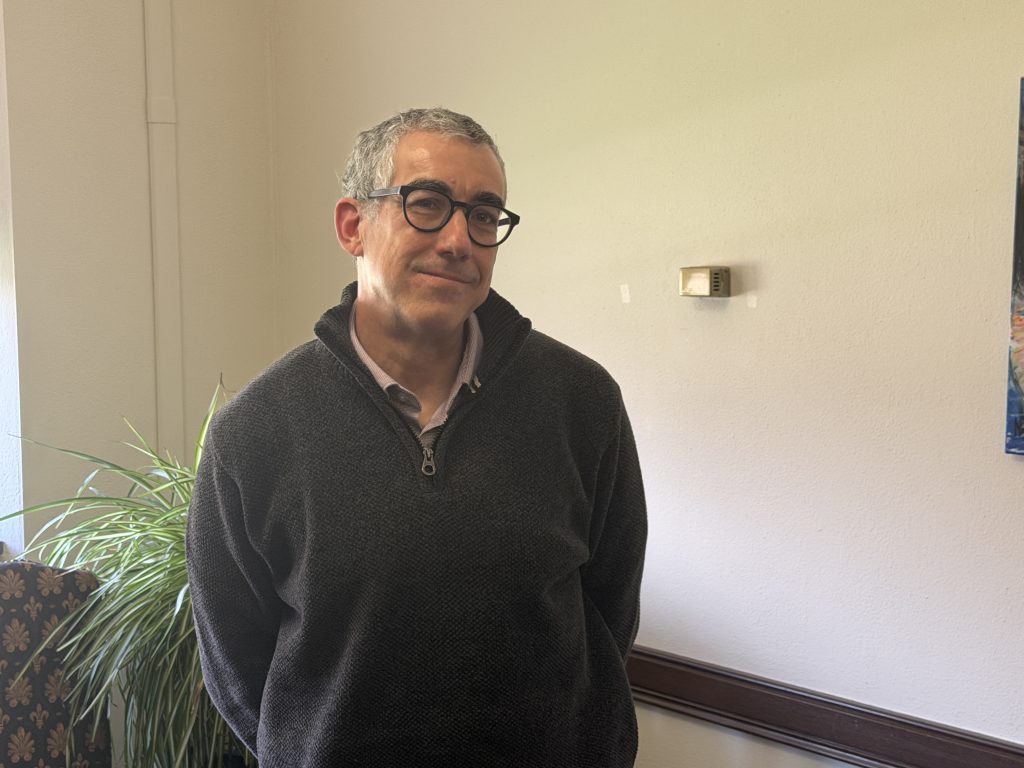 Dave Clark, Vice Provost for Academic Affairs at the University of Wisconsin-Milwaukee. Standing in his office